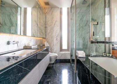 Modern bathroom with marble walls and black countertops