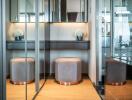 Modern bedroom vanity area with mirror and stools