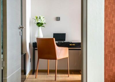 Modern home office with a sleek desk and leather chair