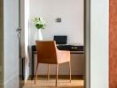 Modern home office with a sleek desk and leather chair