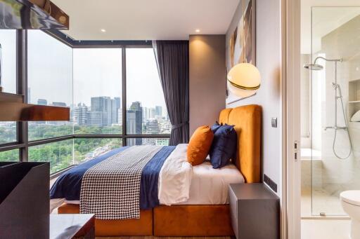 Modern bedroom with city view and attached bathroom