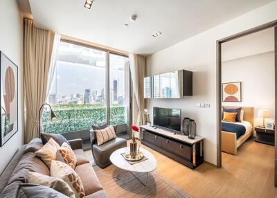 Modern living room with a view of the city, adjacent to a bedroom