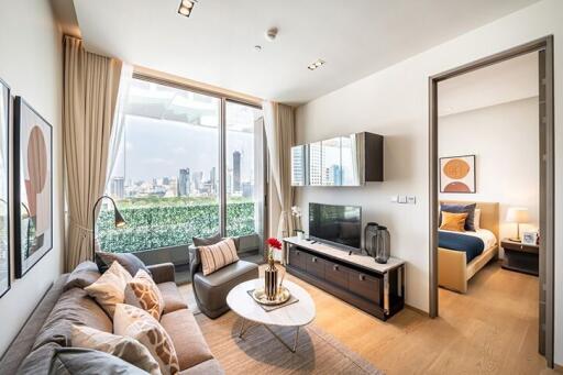 Modern living room with a view of the city, adjacent to a bedroom