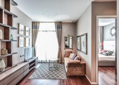 Living room with a TV, sofa, coffee table, large window, and bedroom in the background