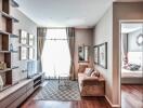 Living room with a TV, sofa, coffee table, large window, and bedroom in the background