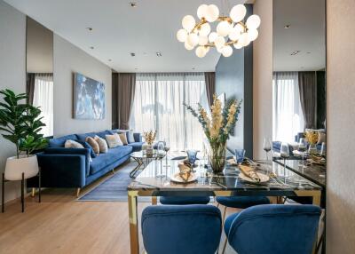 Modern living and dining area with blue sofa and chairs