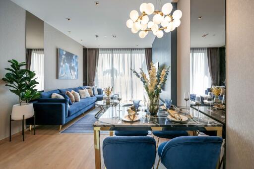 Modern living and dining area with blue sofa and chairs