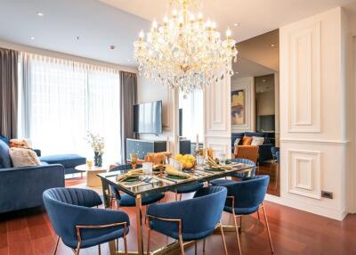 Elegant living and dining area with modern decor and chandelier