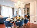 Elegant living and dining area with modern decor and chandelier