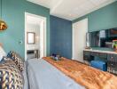 Well-decorated bedroom with attached bathroom, blue and green color scheme, modern decor and furniture