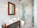 Modern bathroom with marble walls and glass shower