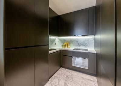 Modern kitchen with sleek cabinetry and marble accents