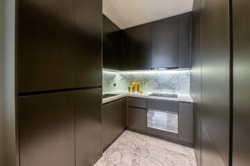 Modern kitchen with sleek cabinetry and marble accents