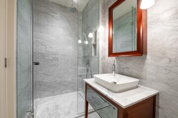 Modern bathroom with marble walls and glass shower