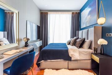 Modern bedroom with blue accents and natural light