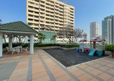 Apartment building with a playground and outdoor seating area