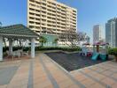 Apartment building with a playground and outdoor seating area