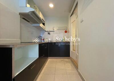 Modern kitchen with cabinetry and tiled flooring