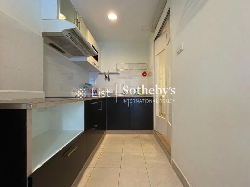 Modern kitchen with cabinetry and tiled flooring