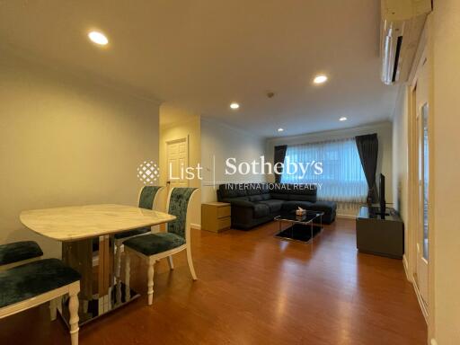 Spacious living room with dining area and large windows