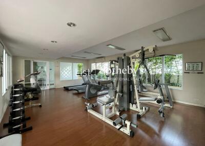 Home gym with various exercise equipment and large windows