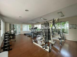 Home gym with various exercise equipment and large windows