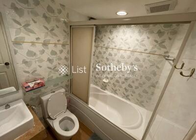 Bathroom with bathtub and floral tile design