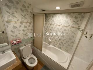 Bathroom with bathtub and floral tile design