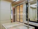 Well-lit walk-in closet with a glass display island