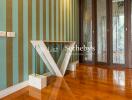 Elegant hallway with striped wallpaper and unique V-shaped glass table