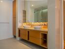 Modern bathroom with dual sinks and large mirror