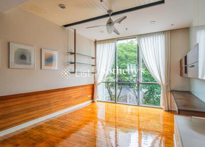 Spacious living room with large windows and wooden flooring