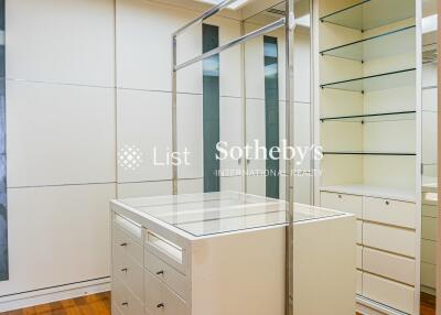 Modern walk-in closet with ample storage and island dresser