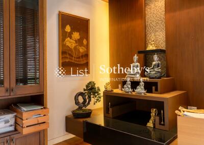 Modern living room with wooden decor and Buddhist sculptures