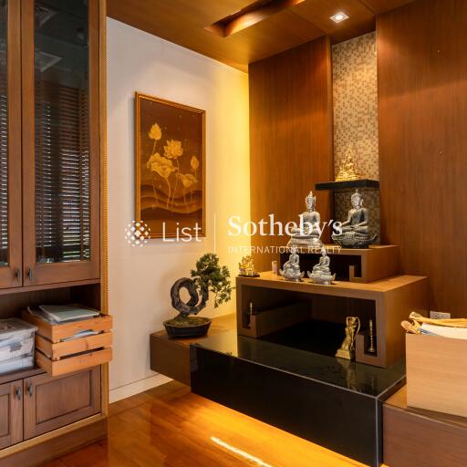 Modern living room with wooden decor and Buddhist sculptures