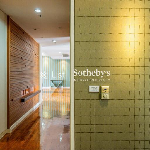 Hallway with wooden accents and a wall with patterned wallpaper