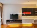 Modern living room with TV, wall-mounted shelves, and large window with curtains.