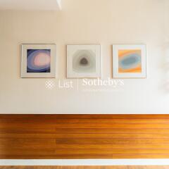 Living room wall with wooden paneling and framed artwork