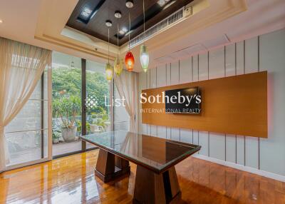 Modern dining area with glass table and stylish lighting