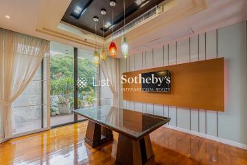 Modern dining area with glass table and stylish lighting