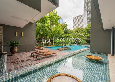 Outdoor area with pool and lounge chairs