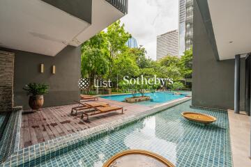 Outdoor area with pool and lounge chairs