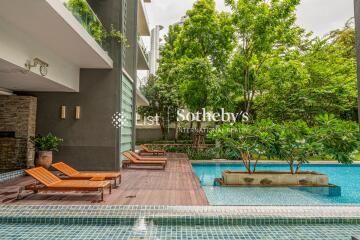 Outdoor area with pool and loungers