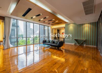 Spacious living room with modern furnishings and large windows