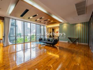 Spacious living room with modern furnishings and large windows