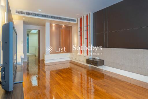 Modern living room with wooden flooring and built-in shelving