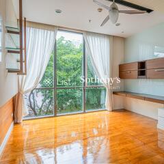 Spacious living room with large windows and abundant natural light