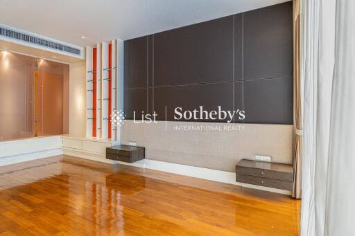 Spacious living room with wood flooring and accent wall