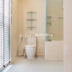 Modern bathroom with glass shelves and bathtub