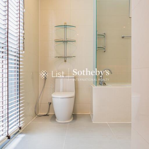 Modern bathroom with glass shelves and bathtub